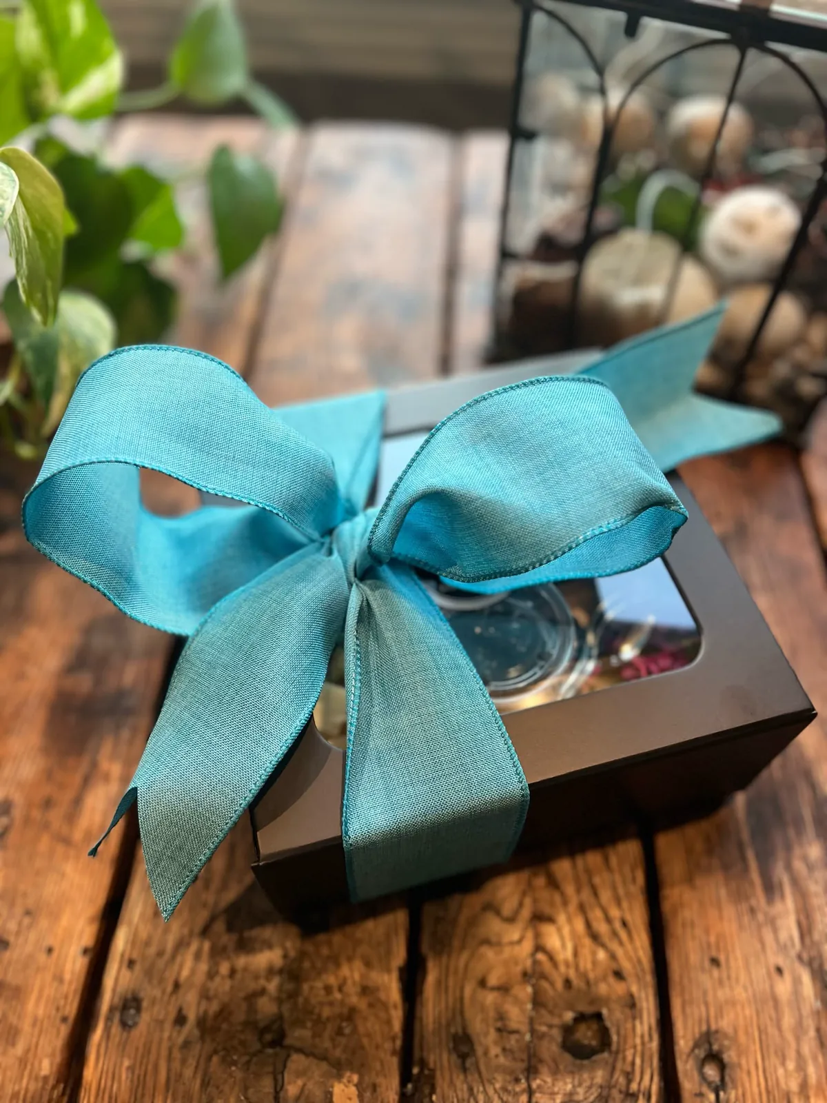 A La Cart charcuterie gift box finished with a turquoise bow