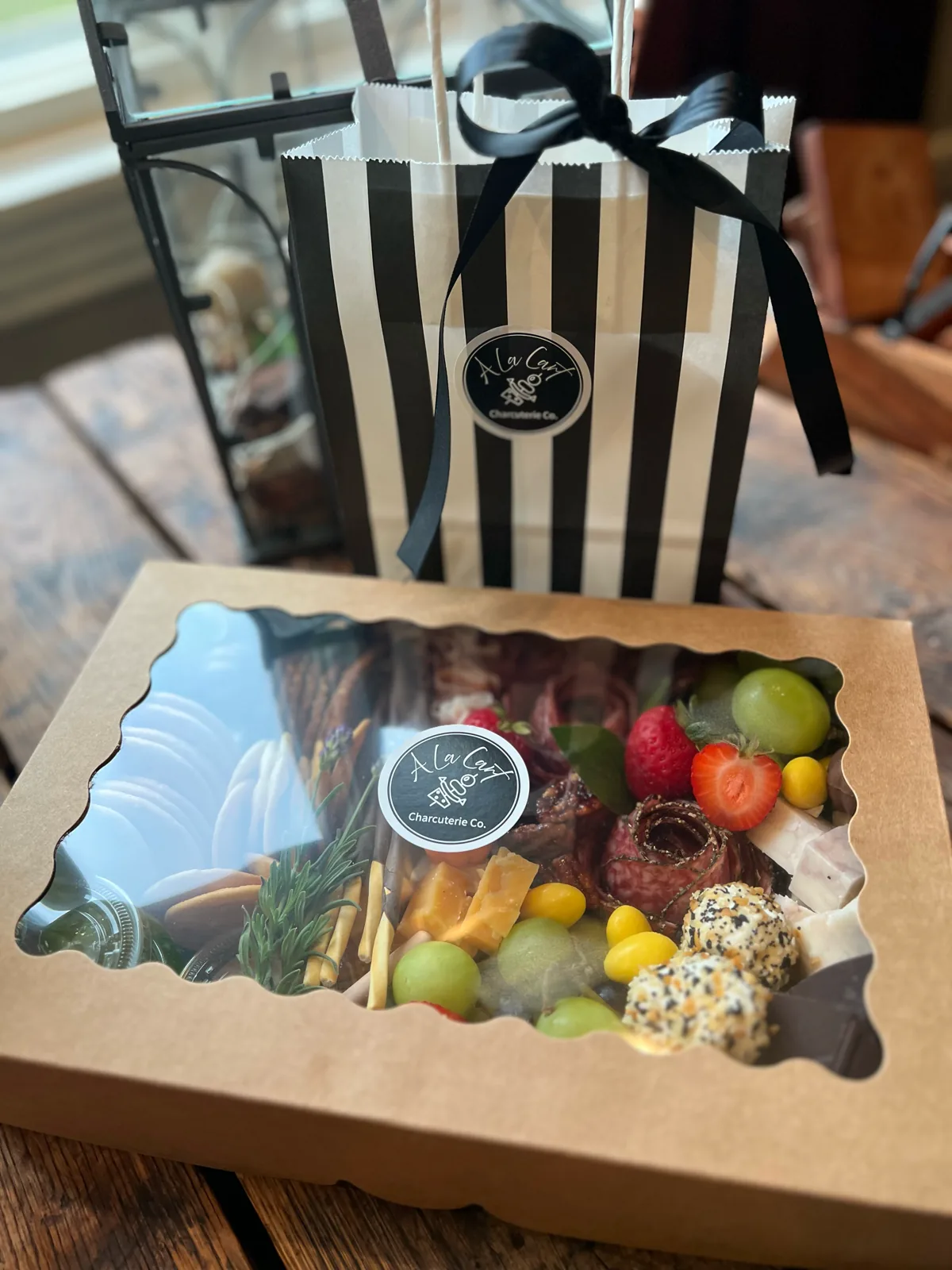 Custom charcuterie box with windowed lid and branded carry bag