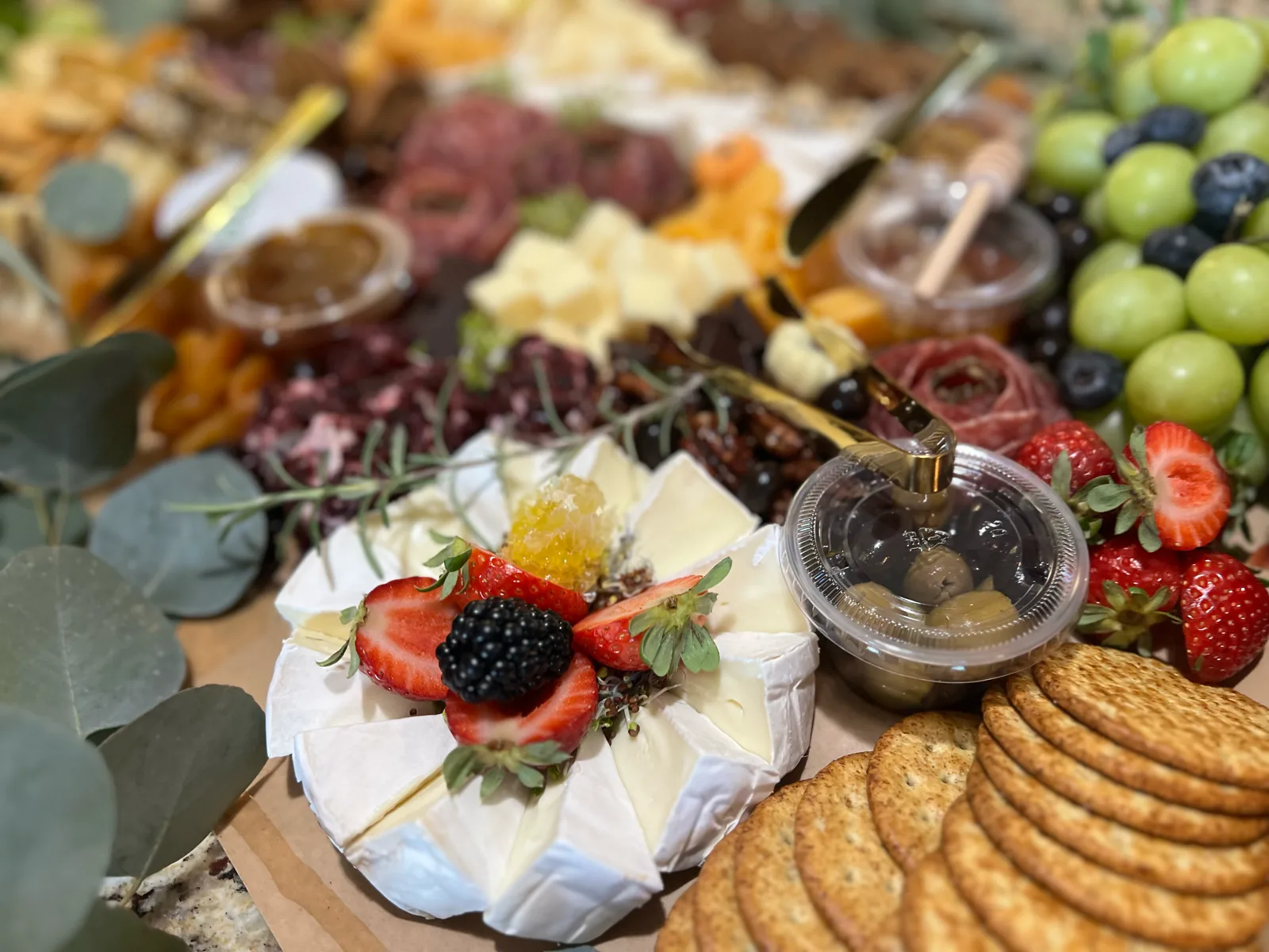 Cheese, berries, and honeycomb on a wedding-morning grazing table